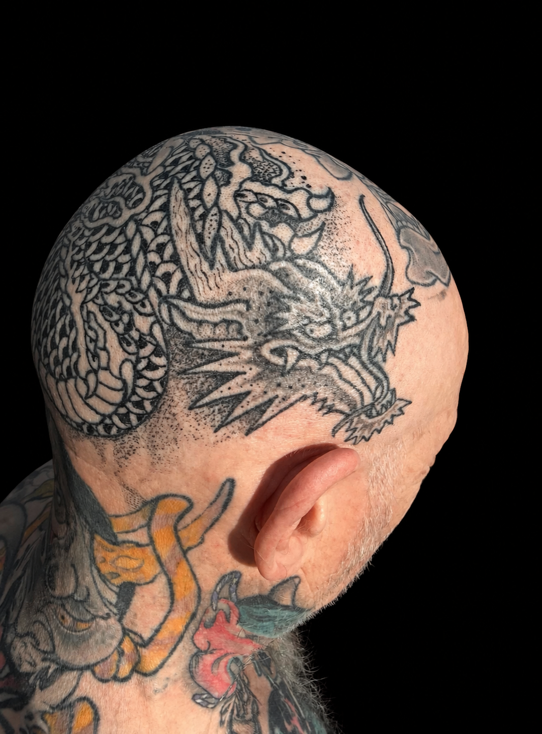 Dragon head tattoo on a solid black background