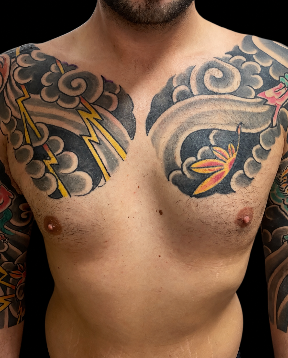 Japanese cloud and lightning chest tattoos with completed sleeves