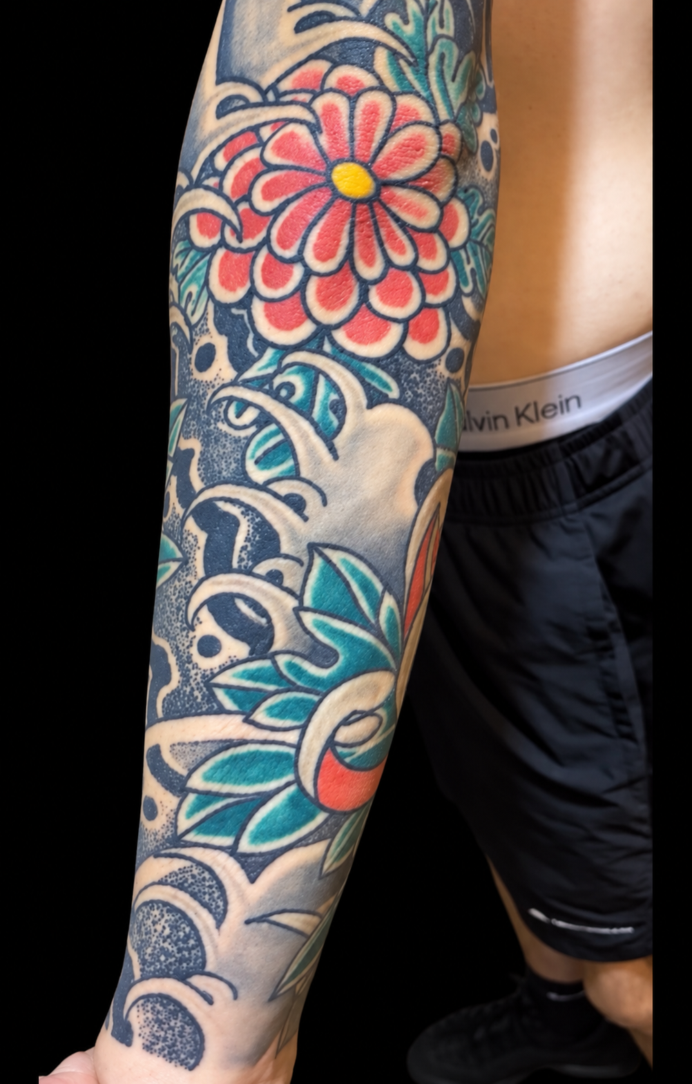 Japanese chrysanthemum and skull sleeve tattoo