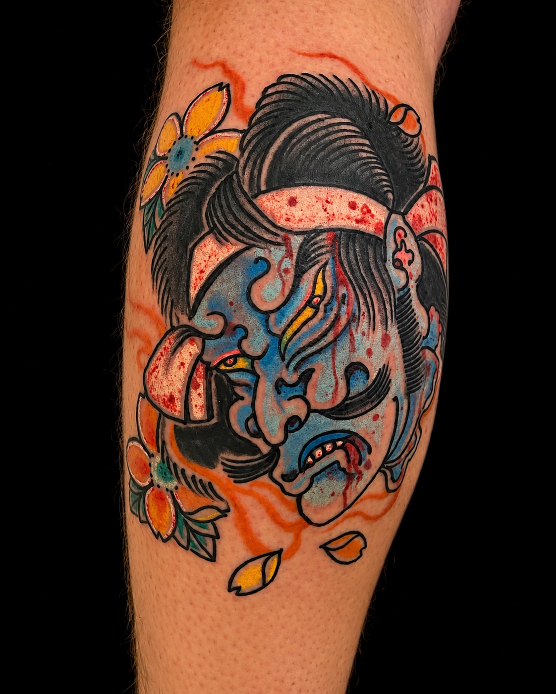 Blue namakubi tattoo with cherry blossoms
