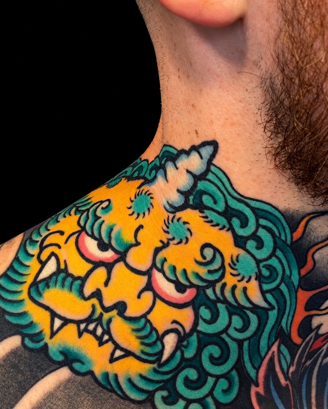 Gold and green shishi chest tattoo