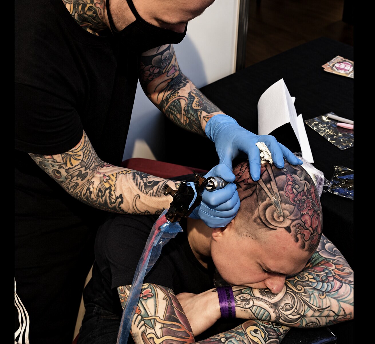 Roddy McLean tattooing a large Japanese head piece