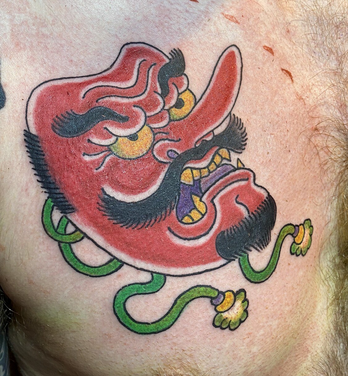 Small colour Japanese Tengu mask tattoo